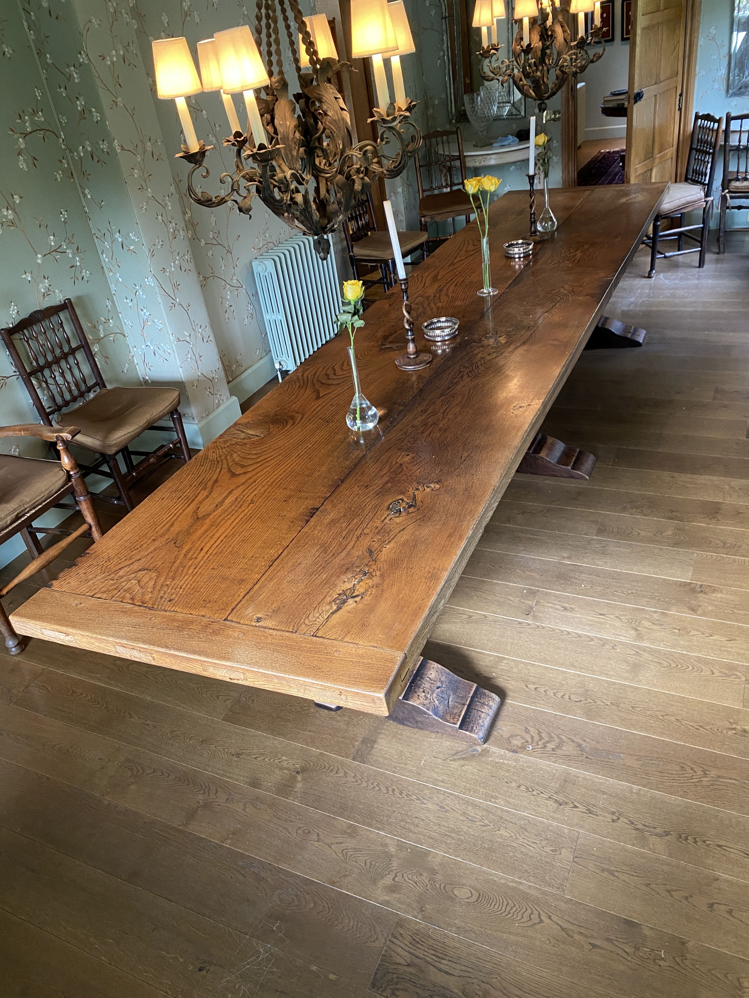 An impressively large 17th century style oak refectory table, with twin plank top on triple baluster supports and trestle foot, width 430cm depth 99cm height 74cm